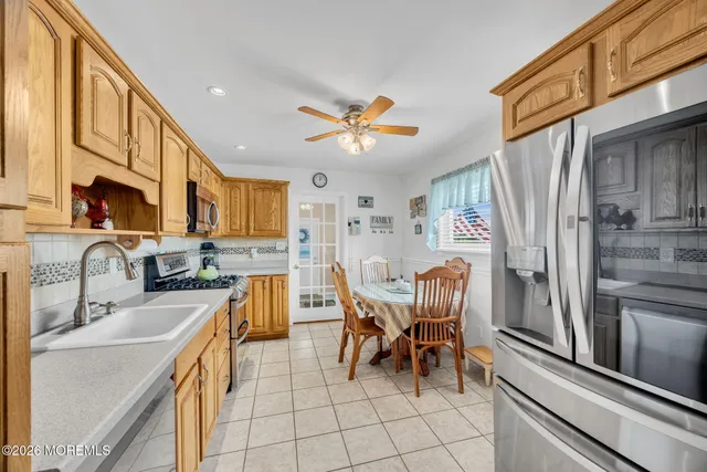 a kitchen with a refrigerator and a sink