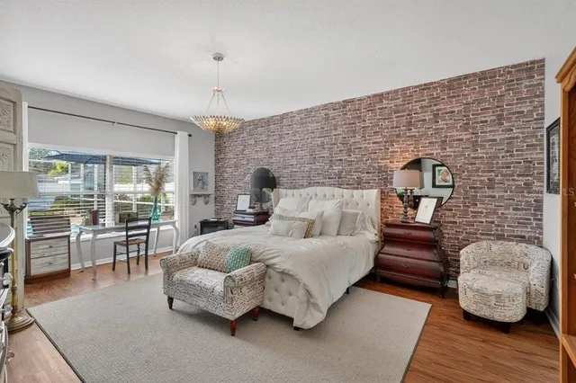 a bedroom with furniture and wooden floor