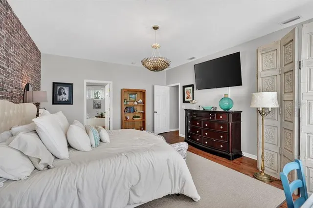 a bedroom with a bed and flat screen tv