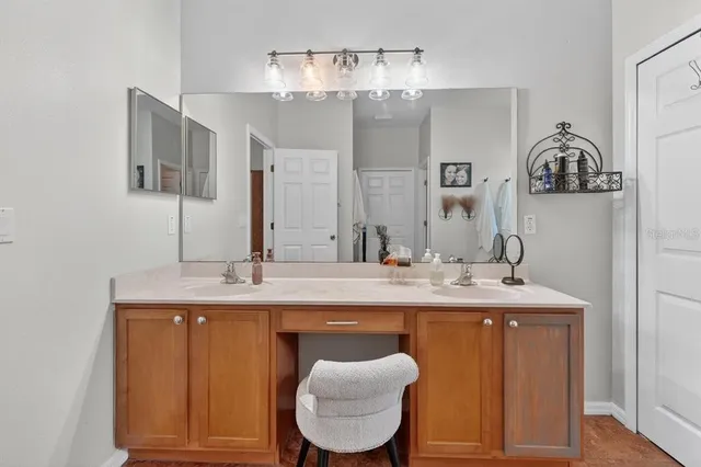 a spacious bathroom with a granite countertop sink and a mirror