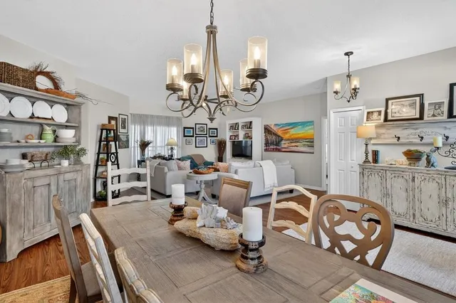 a living room with furniture a chandelier and a flat screen tv