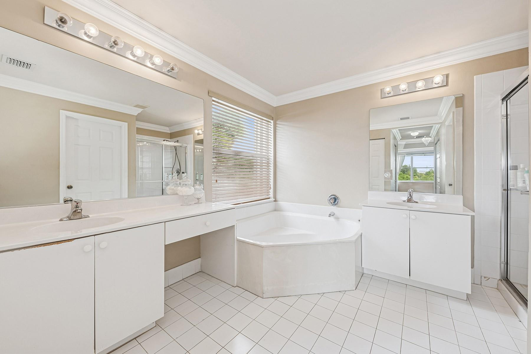 2755 Southwest 165th Avenue Miramar, FL 33027 - Photo 11 of 18 a spacious bathroom with a double vanity sink mirror and bathtub