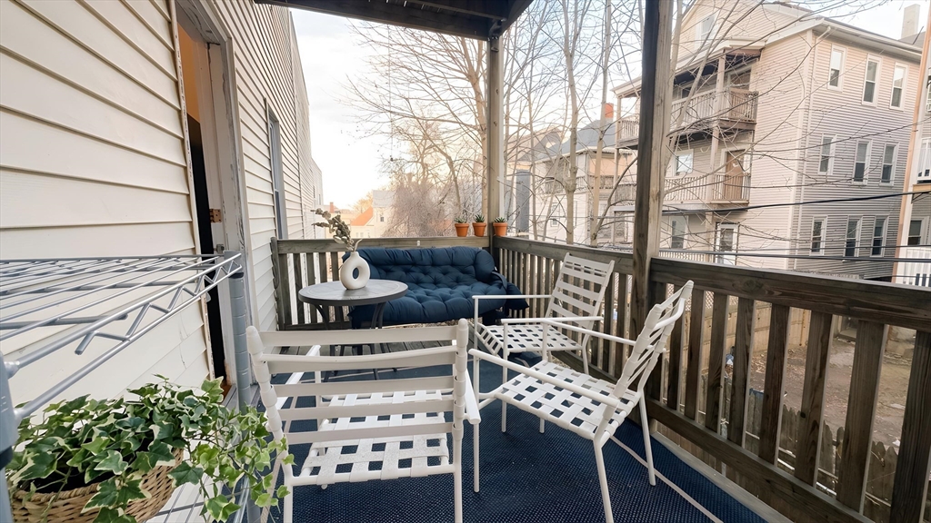 a view of a chairs and table in the balcony