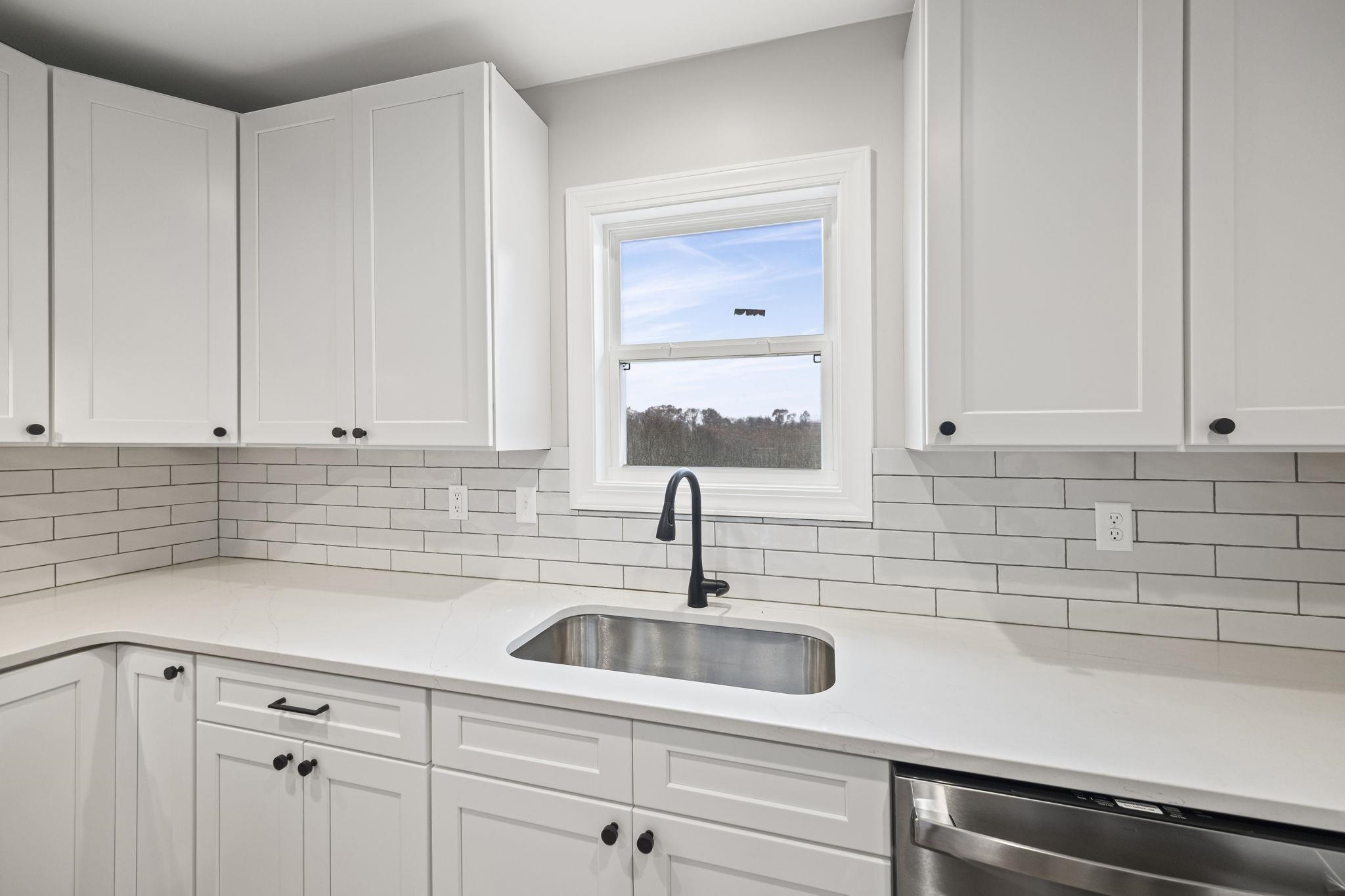 835 Curve Woodville Road Gates, TN 38037 - Photo 8 of 30 Kitchen featuring white cabinetry, dishwasher, and light stone countertops