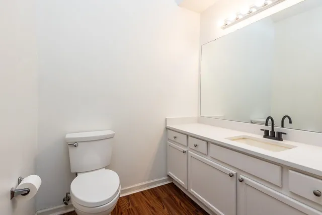 a bathroom with a toilet a sink and mirror
