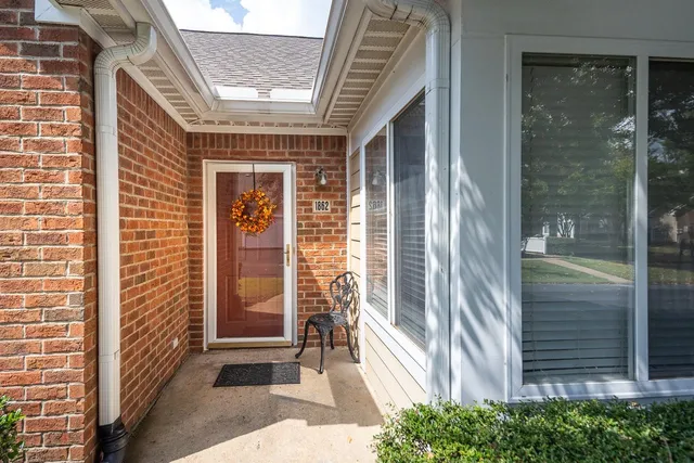a front view of a house with a large window