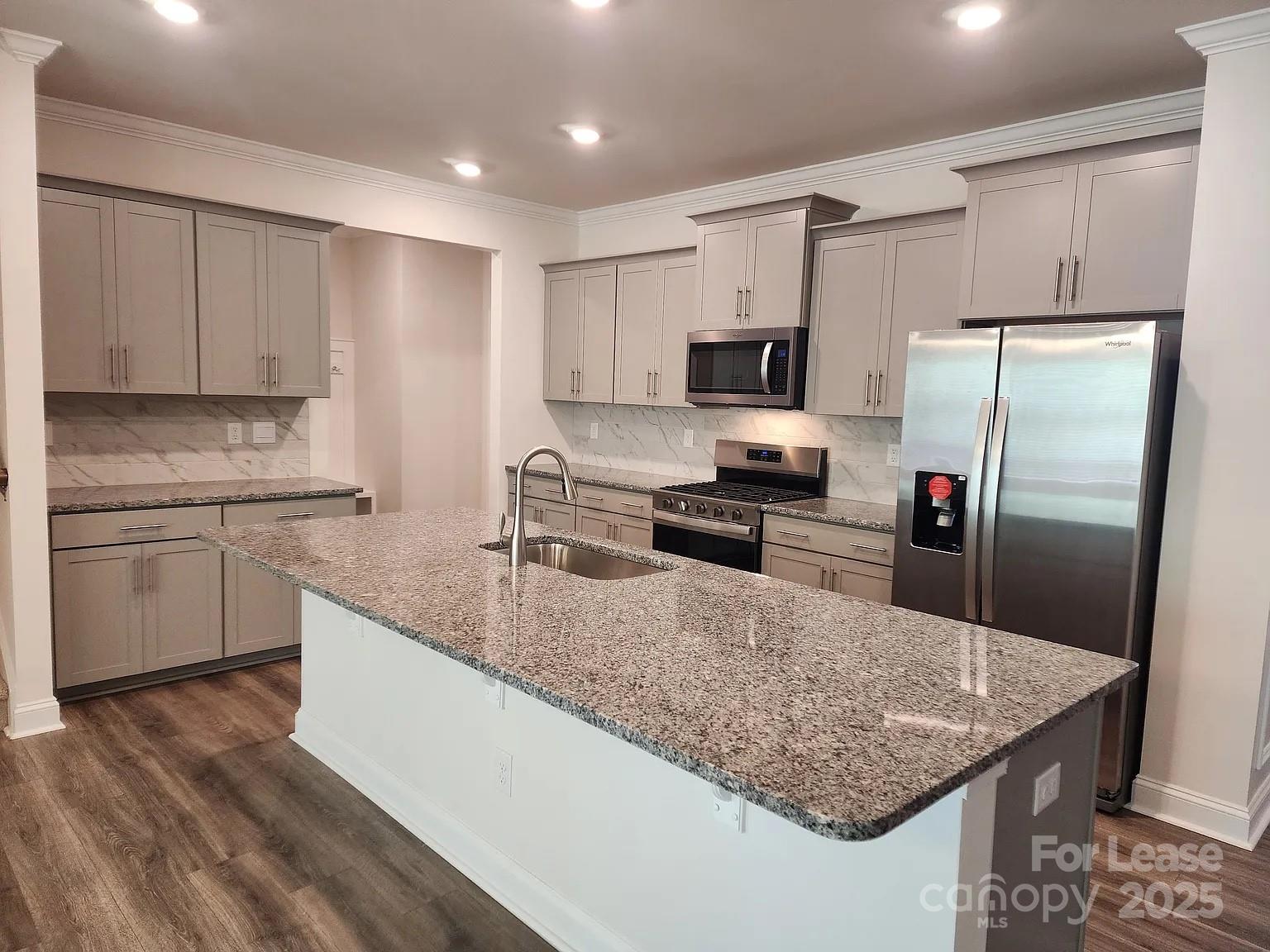 4146 Steel Way Sherrills Ford, NC 28673 - Photo 4 of 12 a kitchen with kitchen island a counter top space cabinets stainless steel appliances and a counter space