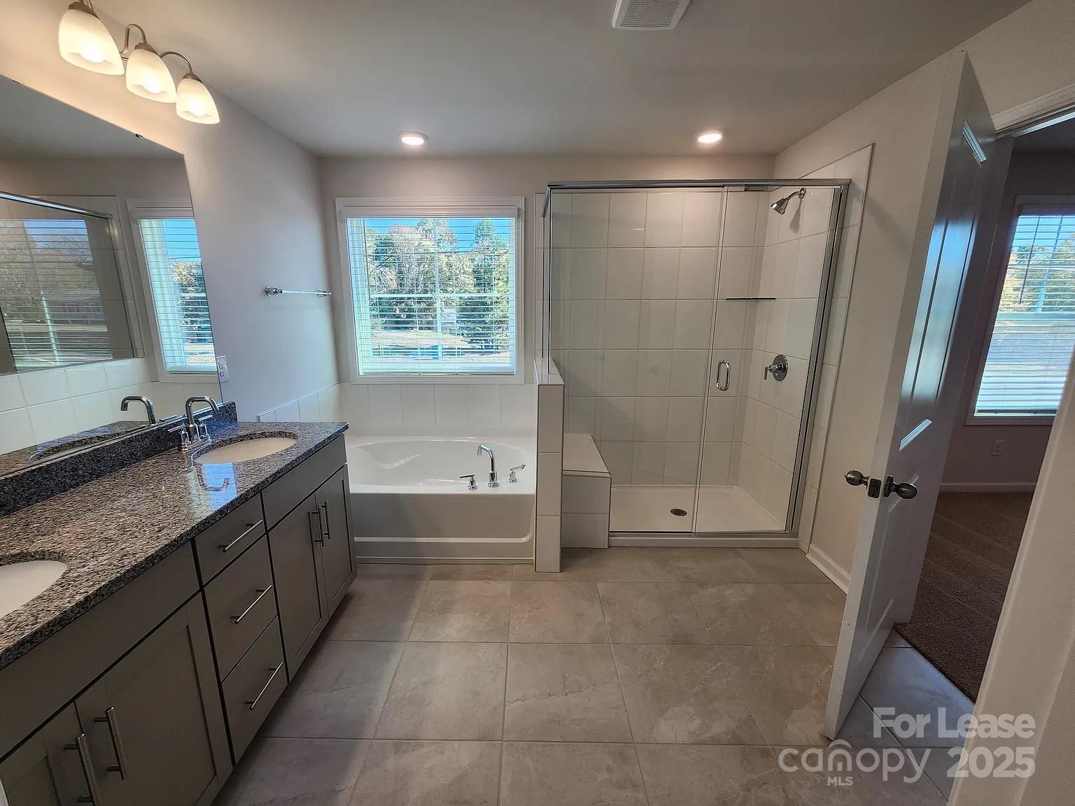 4146 Steel Way Sherrills Ford, NC 28673 - Photo 9 of 12 a bathroom with a granite countertop sink toilet and shower