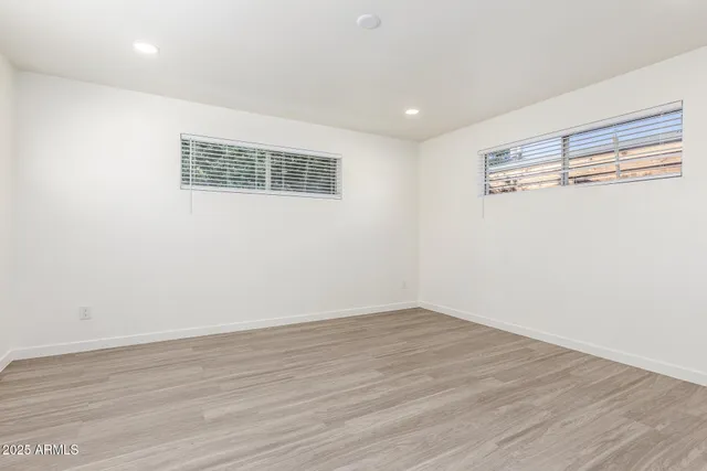 a view of an empty room with wooden floor