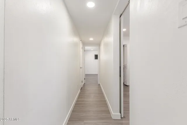 a view of a hallway with wooden floor