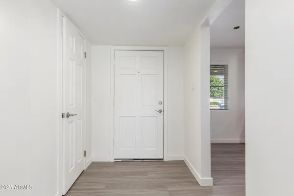 a view of a hallway with wooden floor