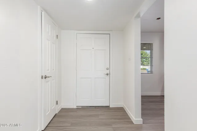 a view of a hallway with wooden floor