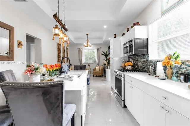 a kitchen with sink a stove and cabinets