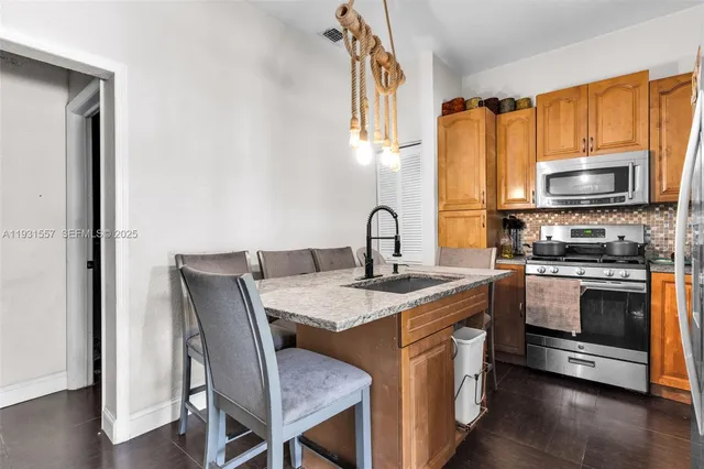 a kitchen with a stove a sink and a microwave