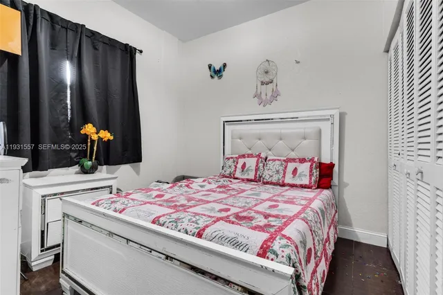 a bedroom with a bed and a mirror