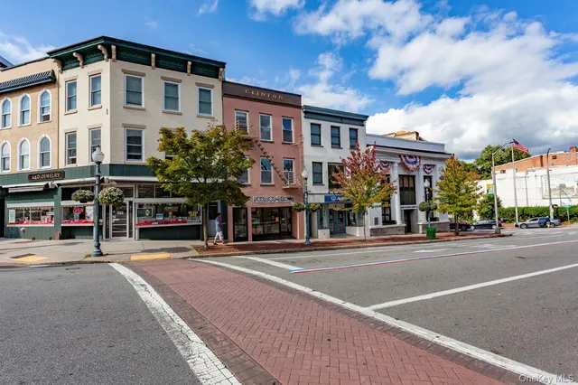 a city street lined with buildings and trees