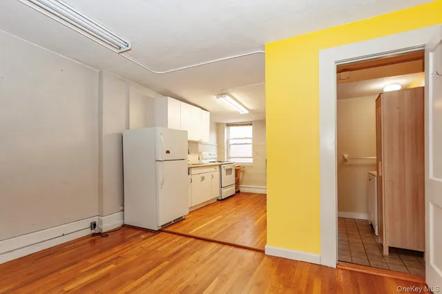 a view of a kitchen with a sink and a refrigerator