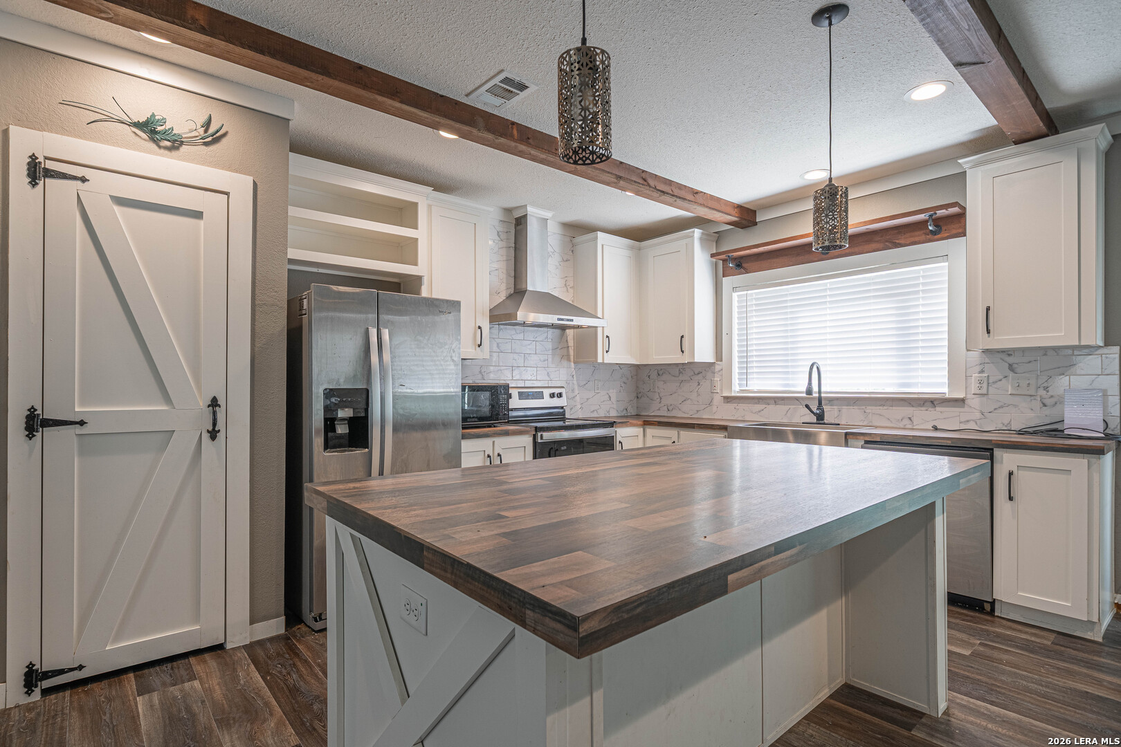 3433 Gander Slough Road Kingsbury, TX 78638 - Photo 4 of 23 a kitchen with stainless steel appliances granite countertop a sink refrigerator and cabinets