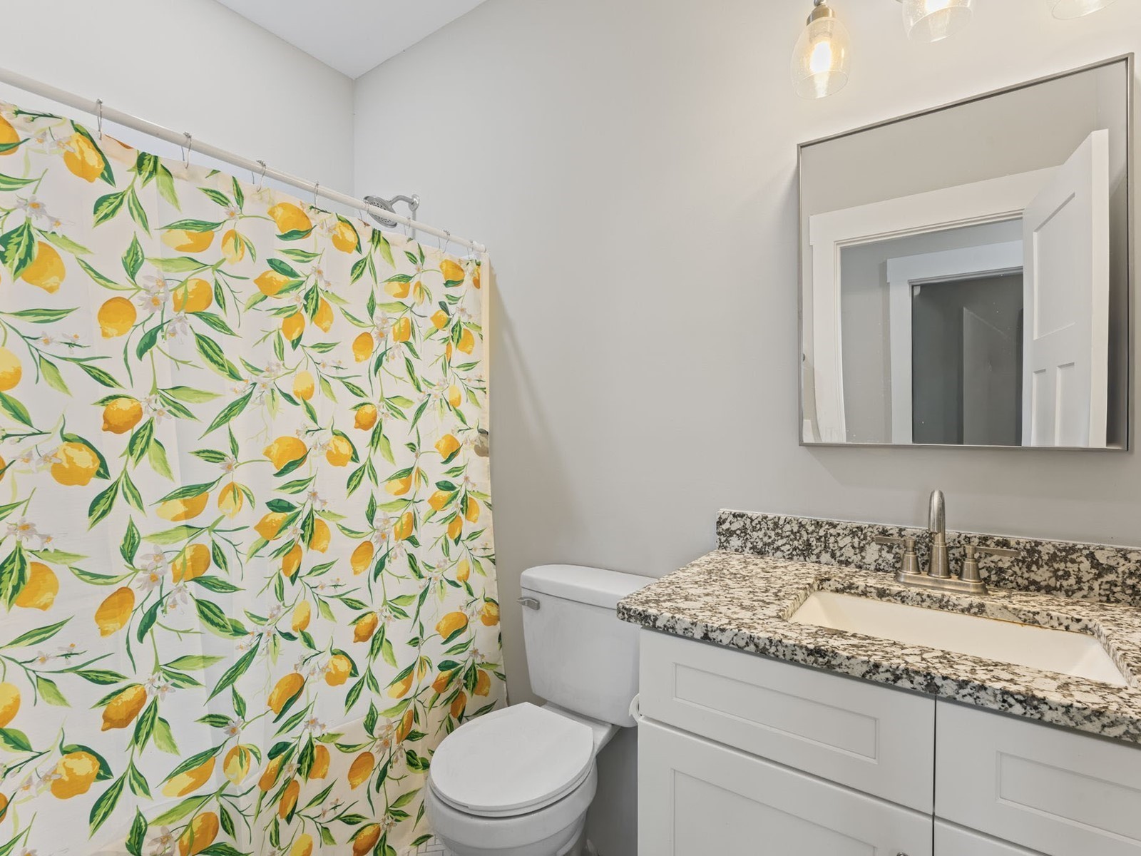 506 Bill Fuson Road McMinnville, TN 37110 - Photo 17 of 22 a bathroom with a granite countertop sink a toilet and a shower curtain