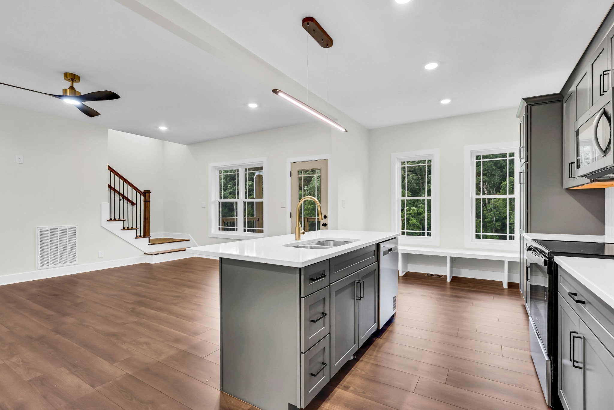5580 Chambers Road Cumberland Furnace, TN 37051 - Photo 15 of 51 a large kitchen with kitchen island a sink dishwasher a stove and a dining table with wooden floor