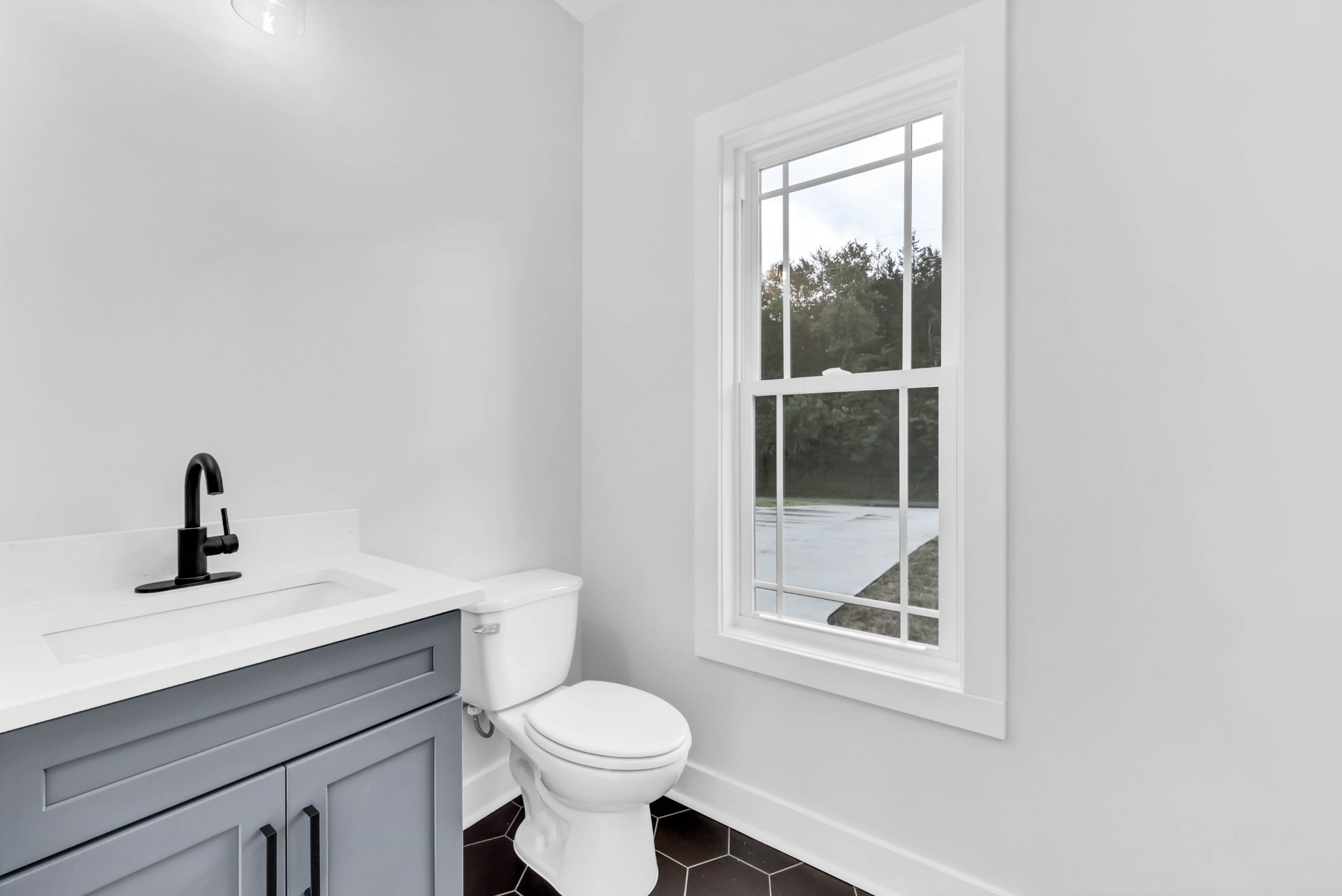 5580 Chambers Road Cumberland Furnace, TN 37051 - Photo 20 of 51 a bathroom with a toilet a sink a window and mirror