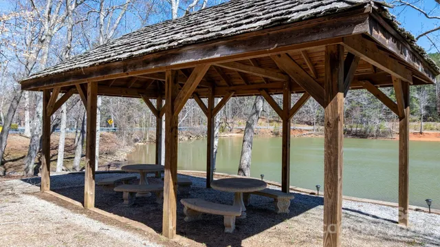 a view of a lake with lawn chairs
