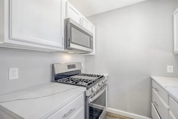 a kitchen with a stove and a microwave