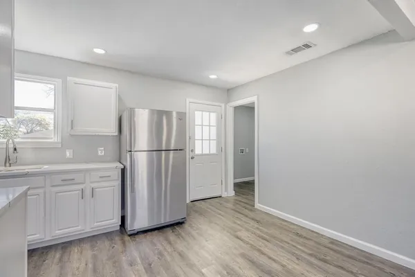 a kitchen with stainless steel appliances a refrigerator sink and cabinets