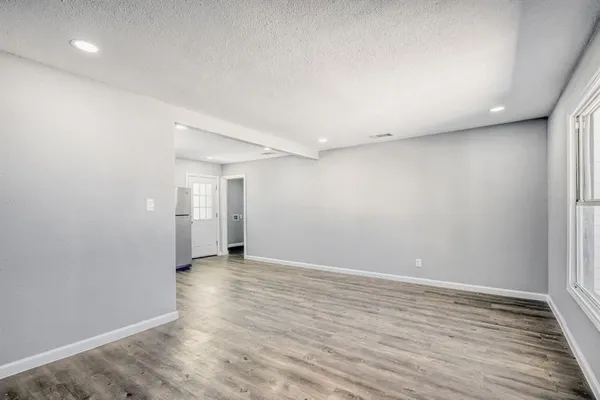 a view of a room with wooden floor