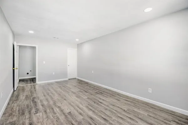 a view of an empty room and wooden floor