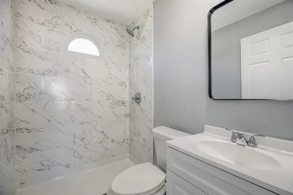 a view of backyard with table and chairs and potted plants