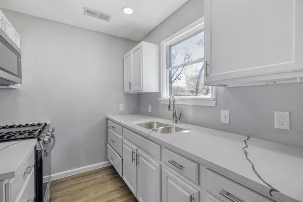 a kitchen with sink cabinets and window