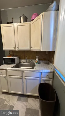 a kitchen with a sink and cabinets