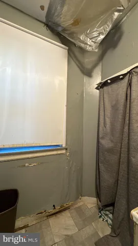 a bathroom with a window and a shower