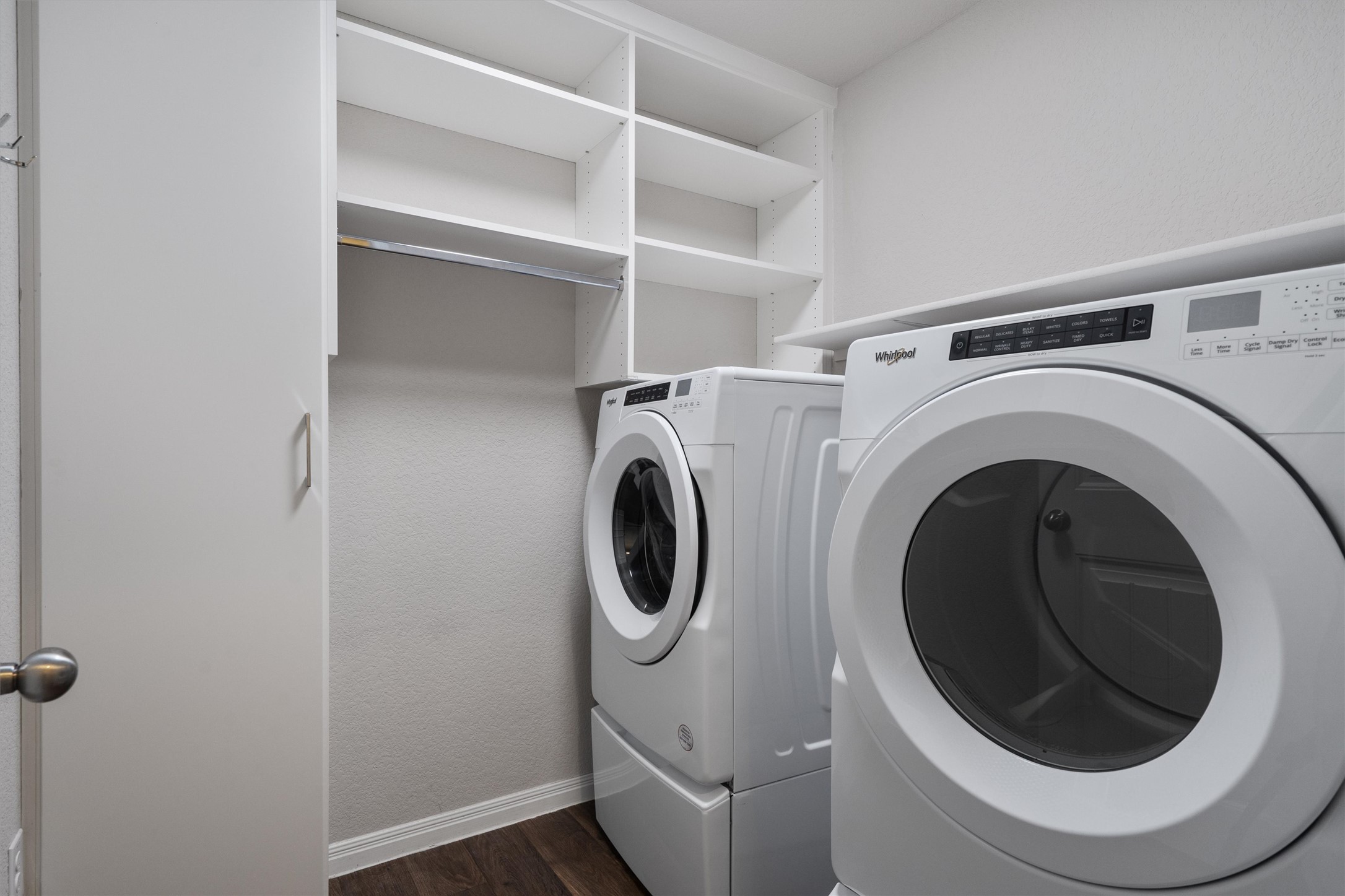 19525 Abigail Fillmore Road Manor, TX 78653 - Photo 27 of 38 Functional laundry space featuring built-in shelving and efficient, stacked appliances.