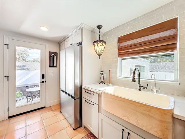 a kitchen with stainless steel appliances and white cabinets