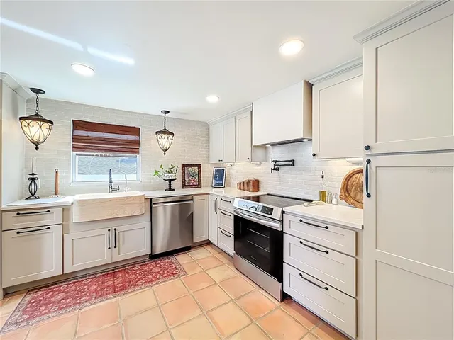 a kitchen with a stove oven and sink