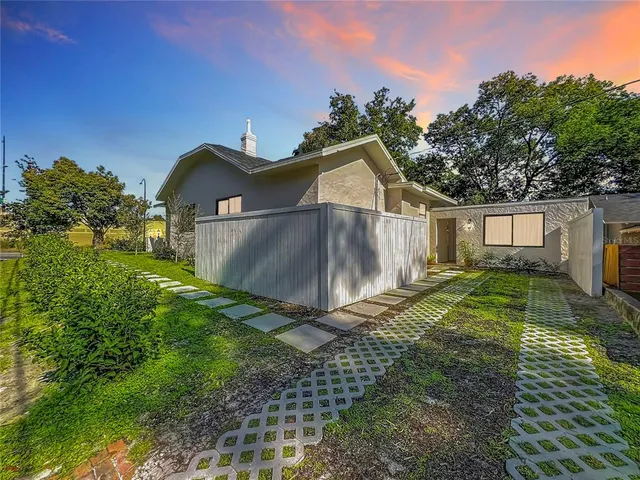 a view of a wooden house with a yard
