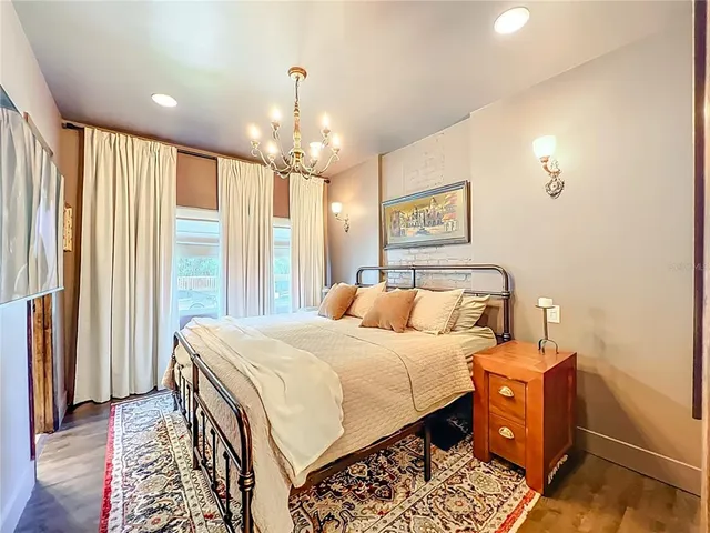 a bedroom with a bed and a chandelier