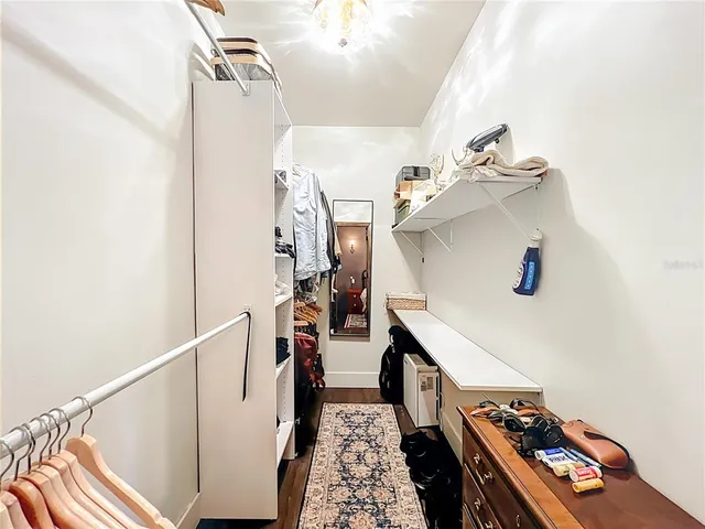 a bedroom with a bed a table and chair