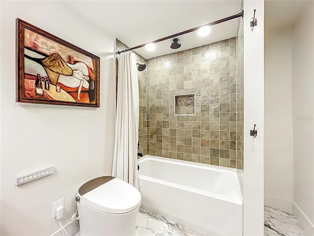 a bathroom with a bathtub and a window