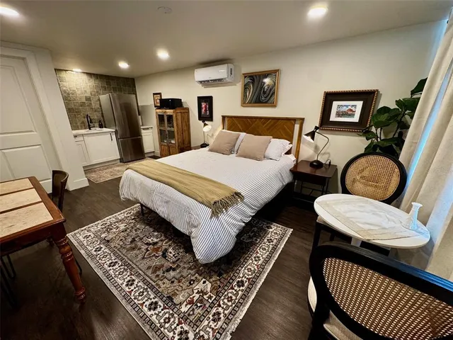 an aerial view of residential houses with outdoor space and trees