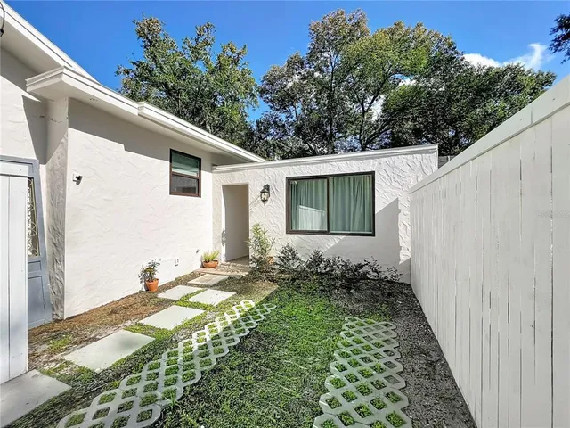 a view of a house with a yard and plants