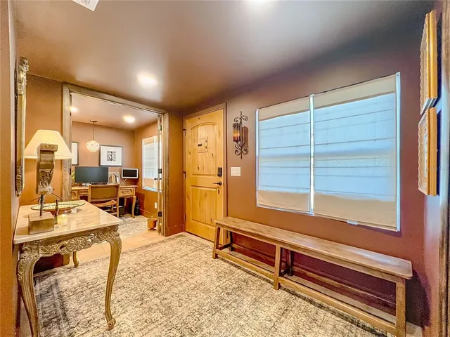 a living room with furniture a wooden floor and next to a window