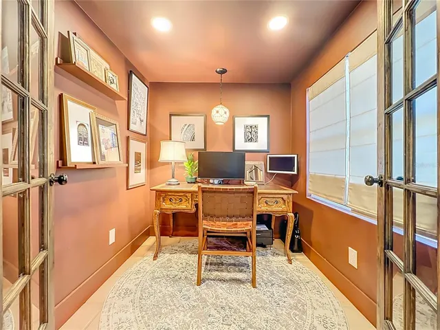 a kitchen with stainless steel appliances kitchen island granite countertop a refrigerator a stove a sink and a dining table with wooden floors