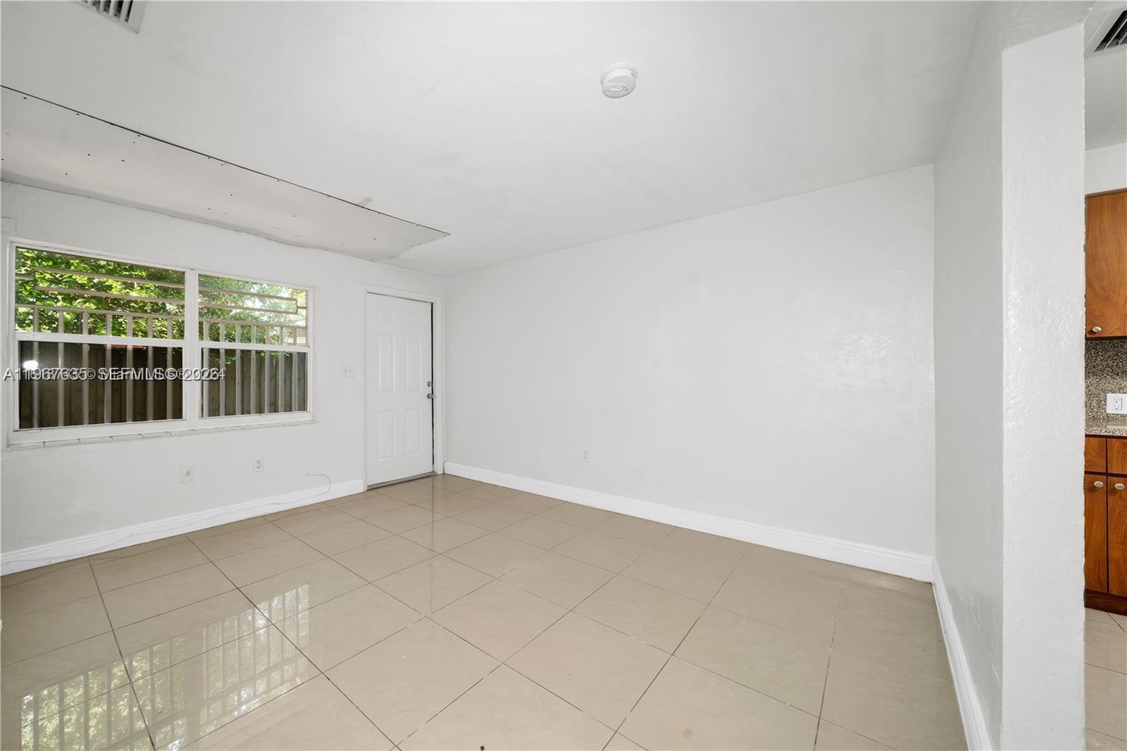 5545 Northwest 3rd Avenue, Unit W Miami, FL 33127 - Photo 4 of 8 a view of an empty room with a window