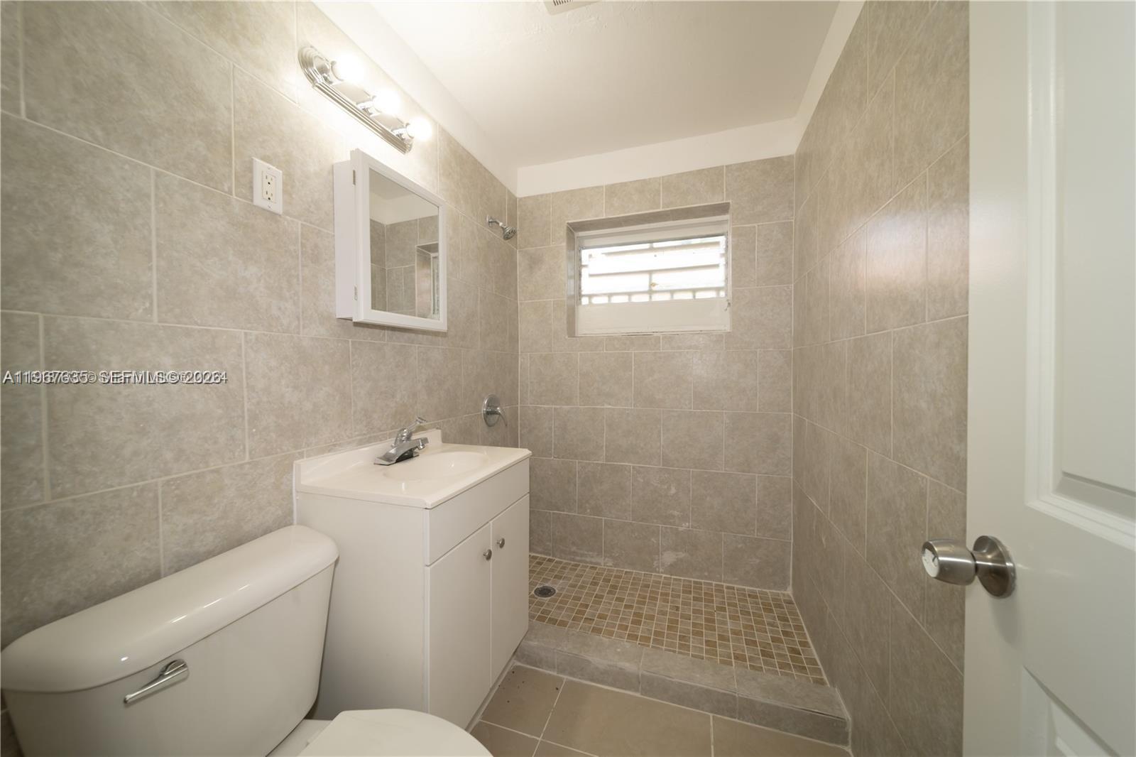 5545 Northwest 3rd Avenue, Unit W Miami, FL 33127 - Photo 7 of 8 a bathroom with a sink toilet and shower