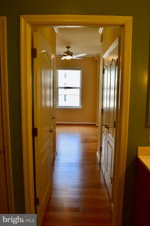 a view of a hallway with wooden floor