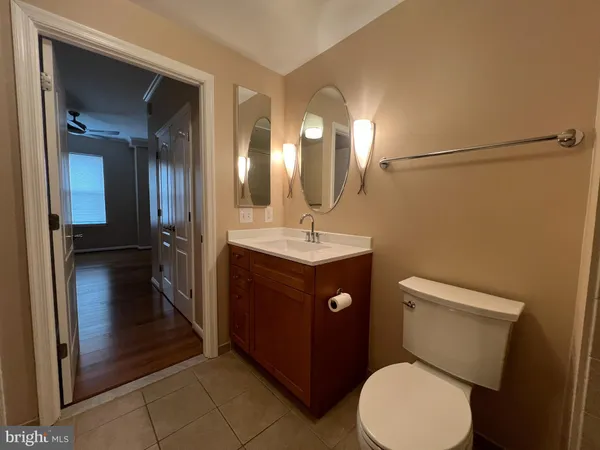 a bathroom with a sink a toilet a mirror a bathtub and shower