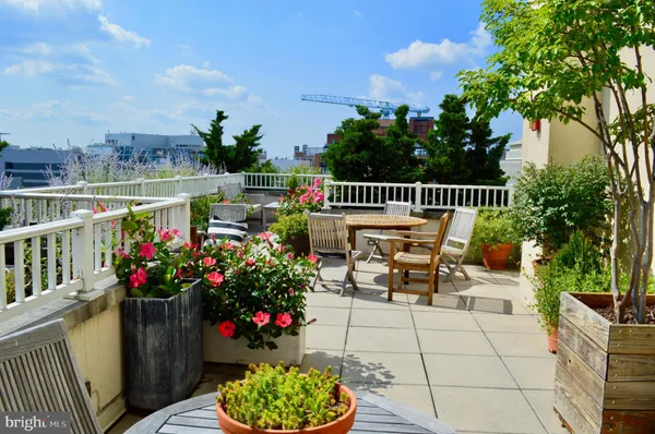 a view of a chairs and table in the back yard of the house